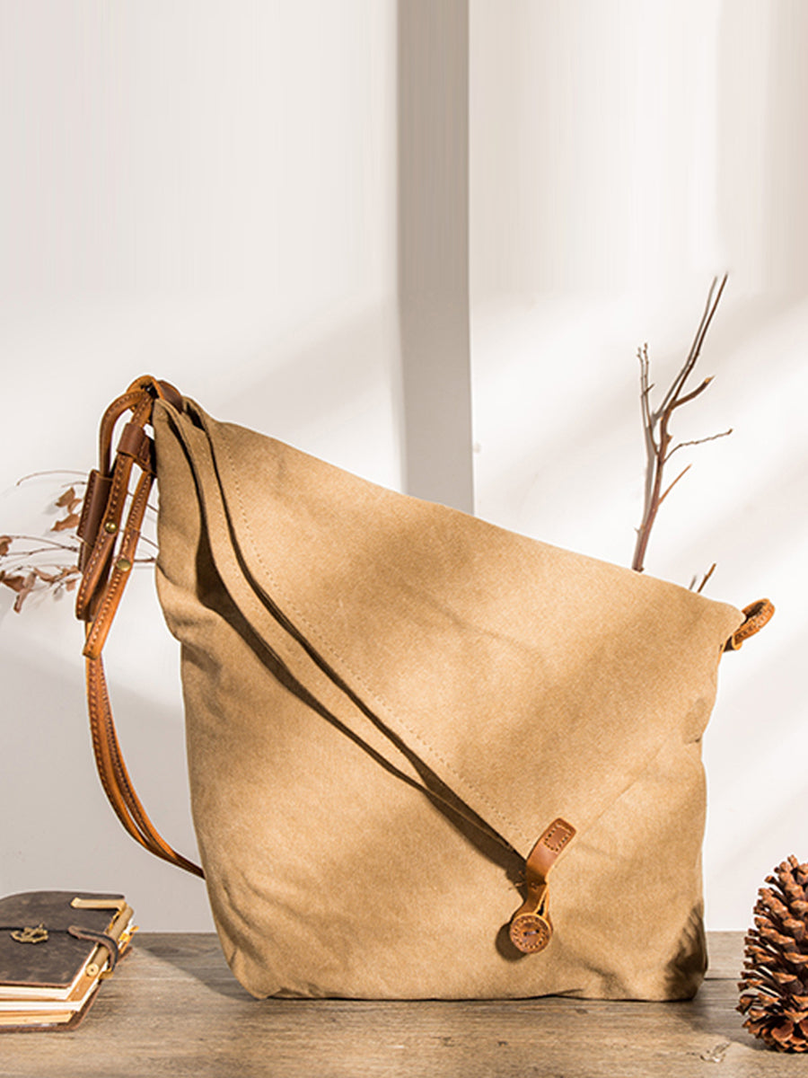 Asymmetrical folded bag with a button, adjustable and stitched