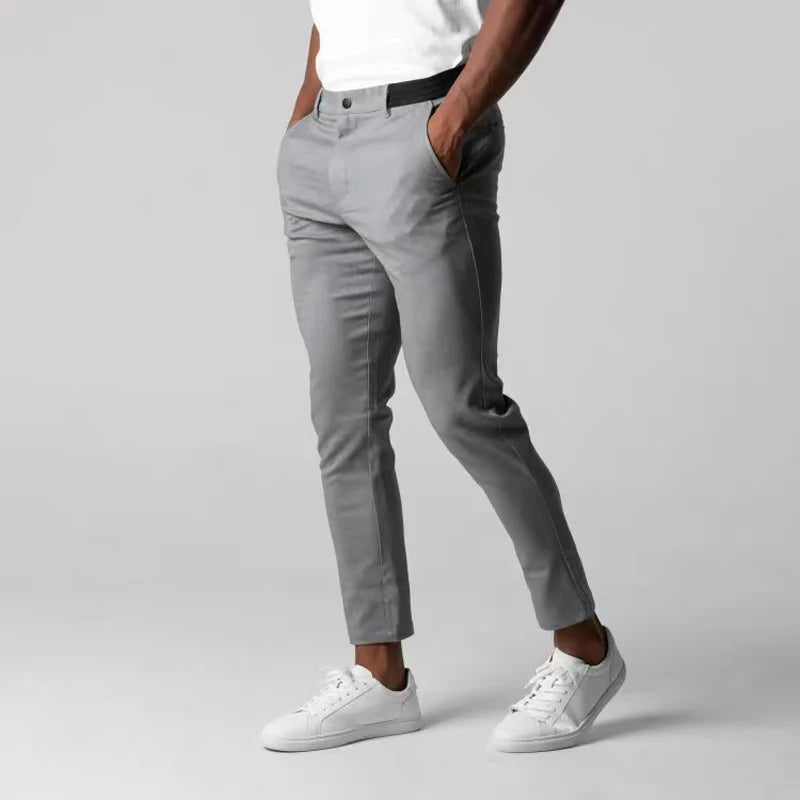 Tapered slim-fit pants with pockets, a button, and finished hems