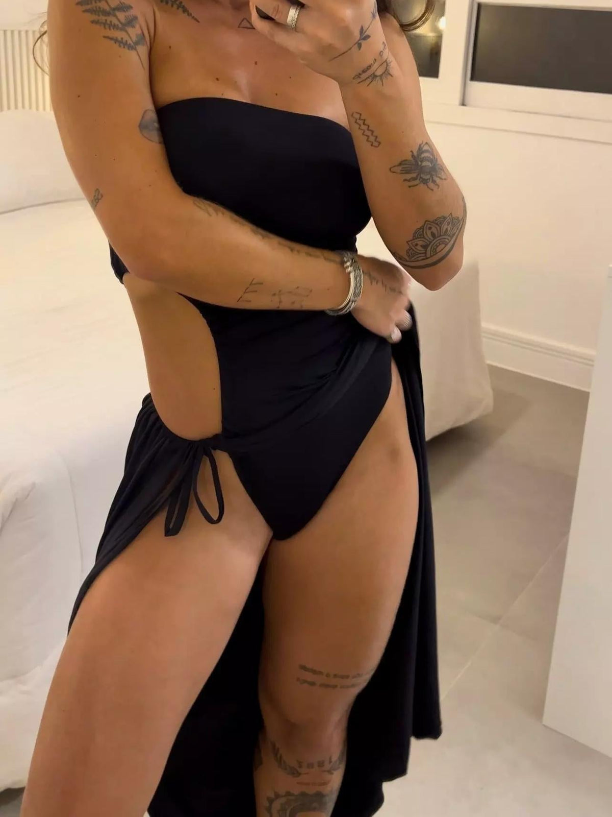 Strapless dress with cutouts, ruching, and a high slit