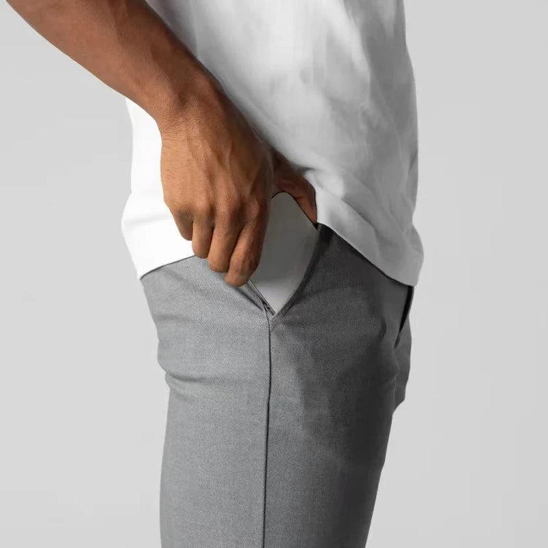Tapered slim-fit pants with pockets, a button, and finished hems