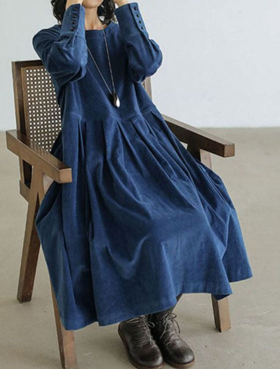 Loose pleated midi dress with a round neckline and long sleeves