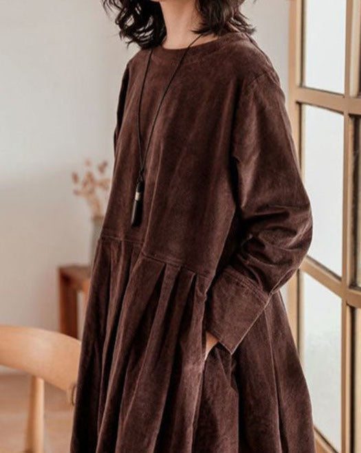 Loose pleated midi dress with a round neckline and long sleeves