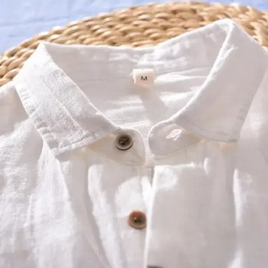 Loose short-sleeved shirt with cuffs, a collar, and a button