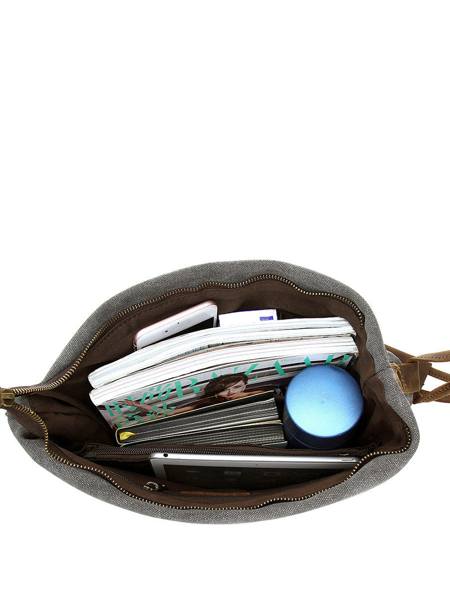 Asymmetrical folded bag with a button, adjustable and stitched