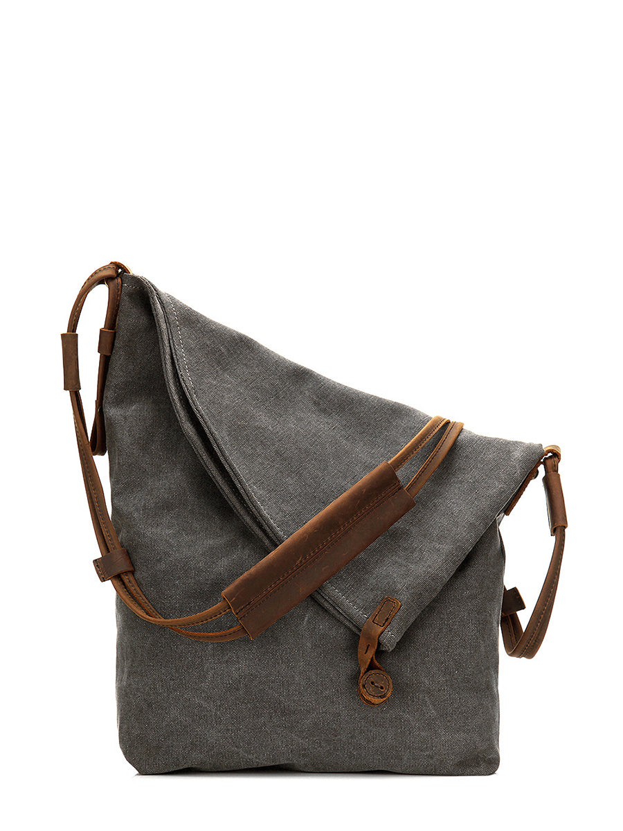 Asymmetrical folded bag with a button, adjustable and stitched