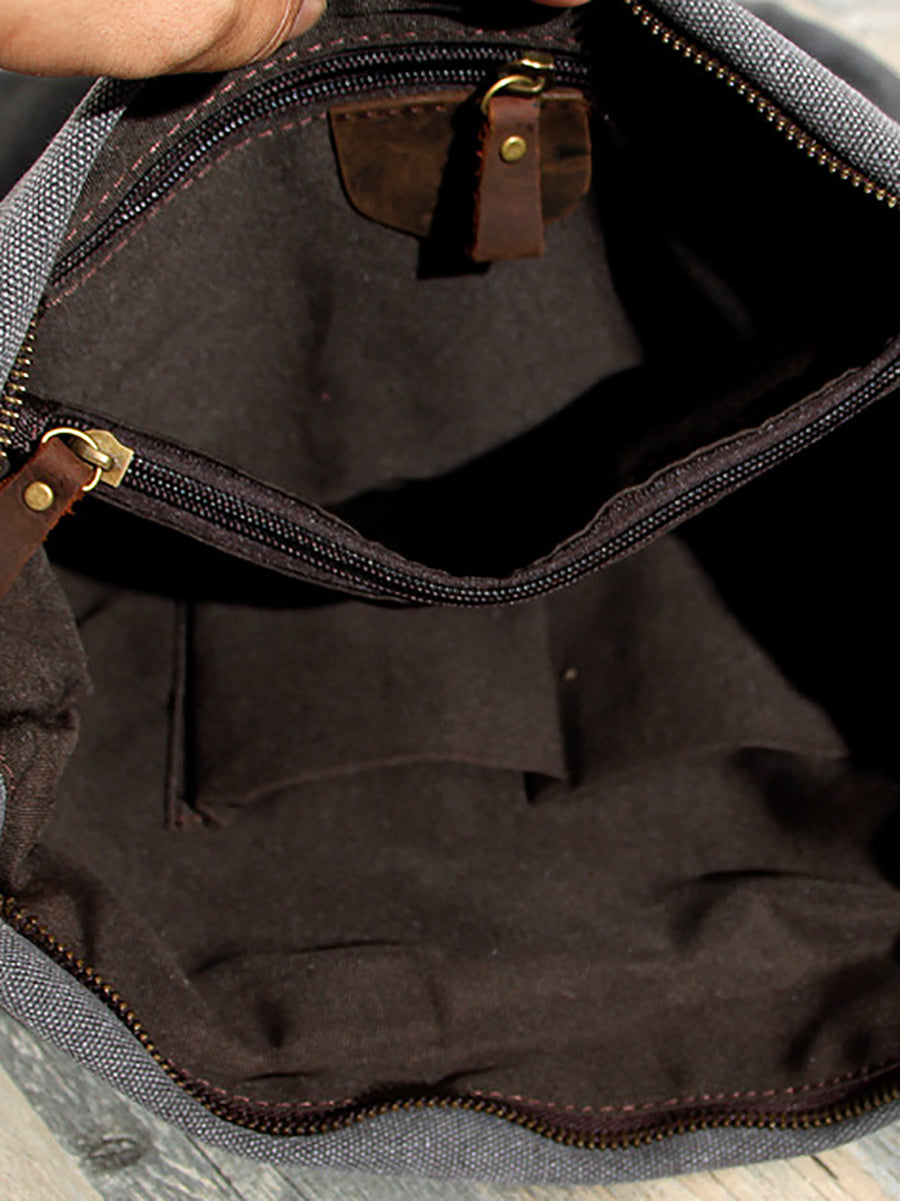 Asymmetrical folded bag with a button, adjustable and stitched