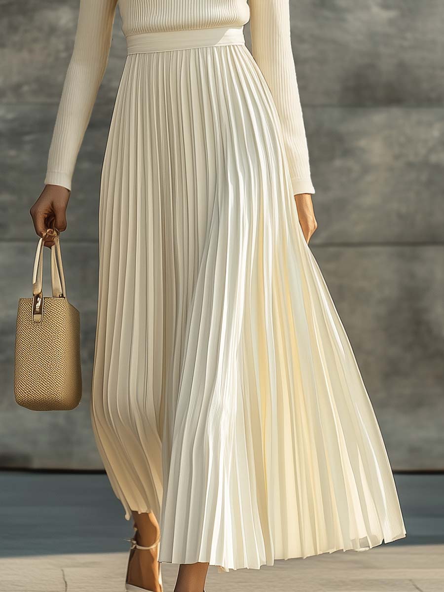 Long knitted maxi dress with a round neckline and pleats