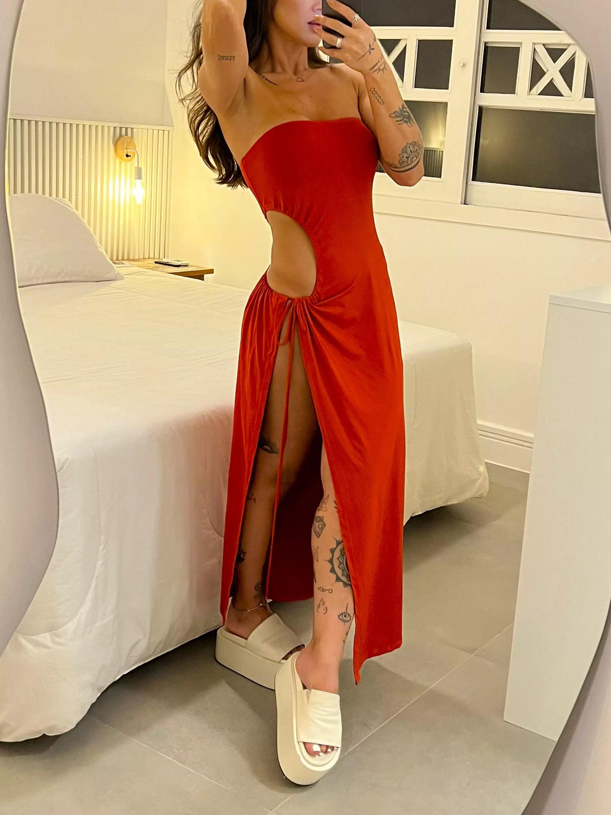 Strapless dress with cutouts, ruching, and a high slit