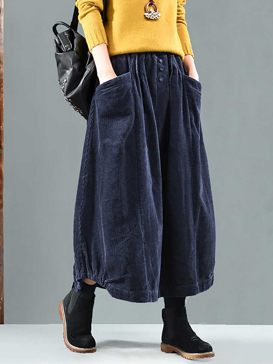 Long, wide, loose pleated skirt with buttons and pockets