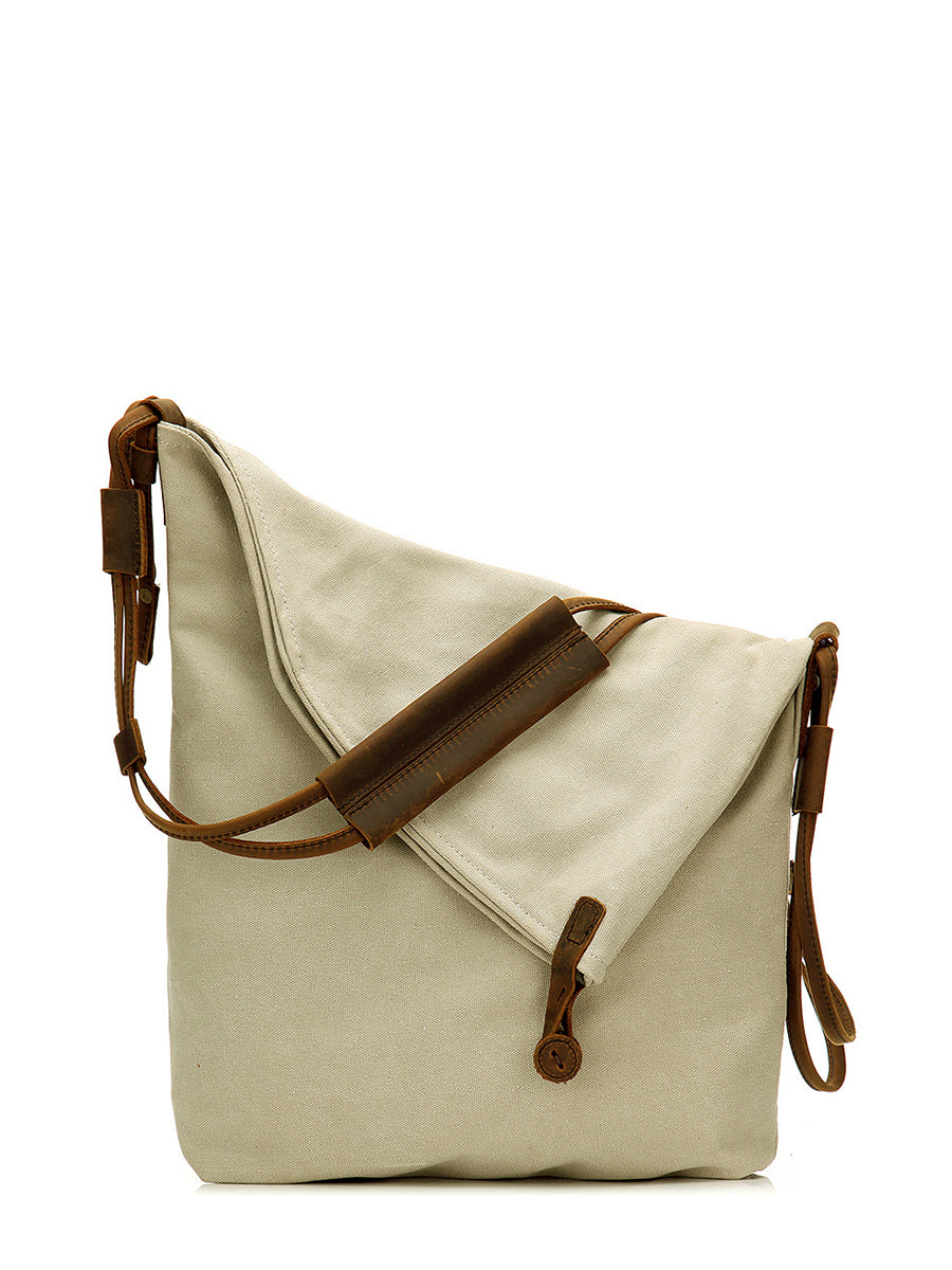 Asymmetrical folded bag with a button, adjustable and stitched