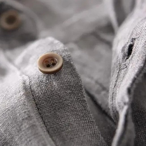 Loose short-sleeved shirt with cuffs, a collar, and a button